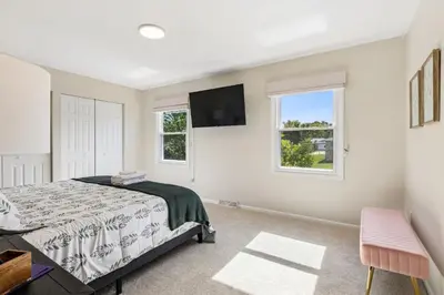 a bedroom with a bed and a tv on the wall at Ultimate Group Escape Heated Pool - 12 Guests in Parma