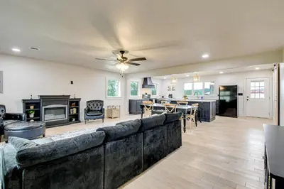 a living room with a large couch and a dining room at 10 Mi to Red River Gorge Peaceful Rural Getaway! in Campton