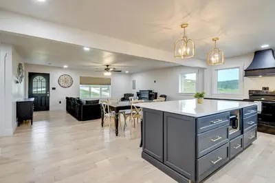 an open kitchen and living room with a dining room at 10 Mi to Red River Gorge Peaceful Rural Getaway! in Campton
