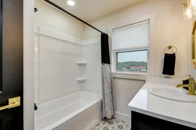 a white bathroom with a tub and a sink at 10 Mi to Red River Gorge Peaceful Rural Getaway! in Campton