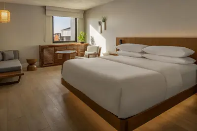 a bedroom with a large white bed with pillows at The Amaya - 21 and older only in Fort Wayne