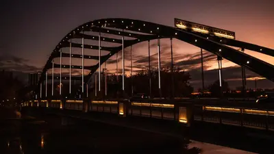 a bridge with a sign on top of it at night at The Amaya - 21 and older only in Fort Wayne