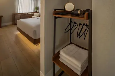 a room with a bedroom with a bed and a mirror at The Amaya - 21 and older only in Fort Wayne