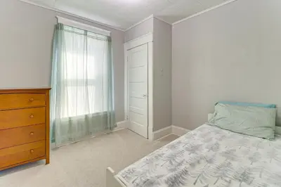 a bedroom with a bed and a dresser and a window at 1 Mi to Dtwn and Franciscan University Home with Yard in Steubenville