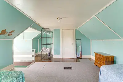 an attic bedroom with blue walls and a ladder at 1 Mi to Dtwn and Franciscan University Home with Yard in Steubenville