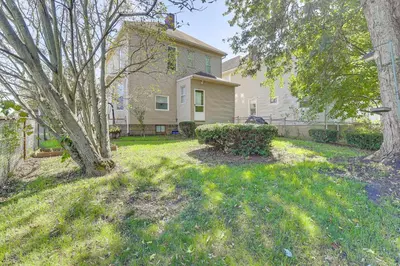 a house with a yard with trees and grass at 1 Mi to Dtwn and Franciscan University Home with Yard in Steubenville