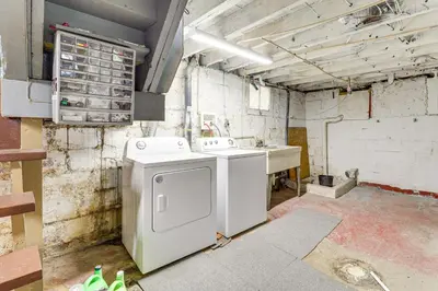 a dirty room with a washing machine and a sink at 1 Mi to Dtwn and Franciscan University Home with Yard in Steubenville