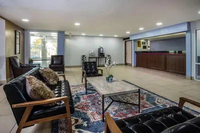 a living room with a couch and a table at Three Rivers Motel in Fort Wayne