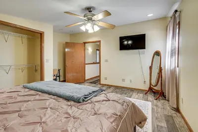 a bedroom with a bed and a ceiling fan at 1 Mi to Main St! Family Farmhouse in West Unity