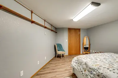 a bedroom with a bed and a chair in it at 1 Mi to Main St! Family Farmhouse in West Unity