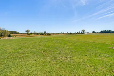 a large field of green grass with a blue sky at 1 Mi to Main St! Family Farmhouse in West Unity
