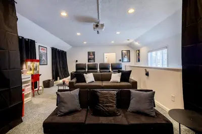 a living room with a couch and a living room at Movie Theater-Game Room-Parking-Heart Of Cleveland in Cleveland