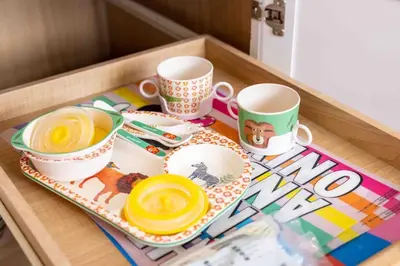 a tray with three cups and plates on a table at Movie Theater-Game Room-Parking-Heart Of Cleveland in Cleveland