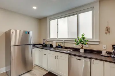 a kitchen with a stainless steel refrigerator and a window at 1 Mi to Cedar Point Family Getaway with Porch! in Sandusky