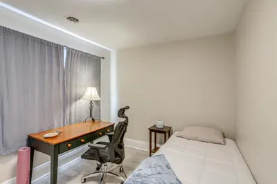a bedroom with a desk and a bed and a bed and a desk and chair at 1 Mi to Cedar Point Family Getaway with Porch! in Sandusky