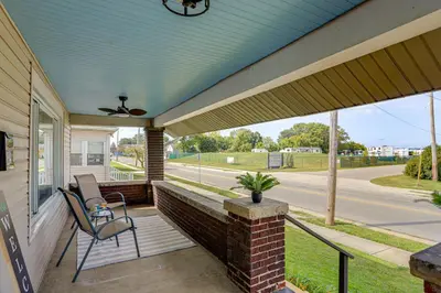 a porch with a chair and a ceiling fan at 1 Mi to Cedar Point Family Getaway with Porch! in Sandusky
