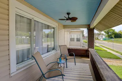 a porch with two chairs and a ceiling fan at 1 Mi to Cedar Point Family Getaway with Porch! in Sandusky