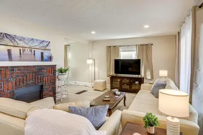 a living room with a couch and a fireplace at 1 Mi to Cedar Point Family Getaway with Porch! in Sandusky