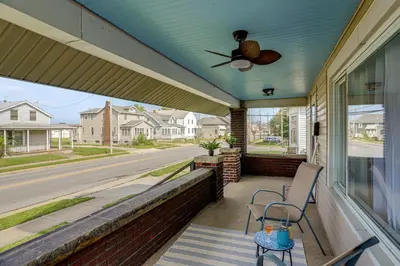 a porch with two chairs and a ceiling fan at 1 Mi to Cedar Point Family Getaway with Porch! in Sandusky