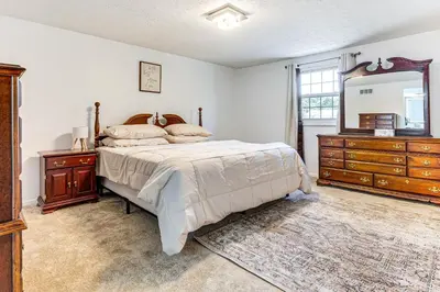 a bedroom with a bed and a dresser and a mirror at Shop, Golf and Explore Home 14 Mi to Columbus! in Pickerington