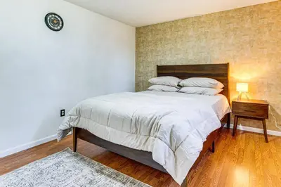 a bedroom with a bed and a night stand with a lamp at Shop, Golf and Explore Home 14 Mi to Columbus! in Pickerington