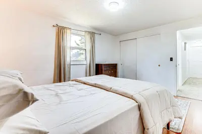 a bedroom with a large white bed with a window at Shop, Golf and Explore Home 14 Mi to Columbus! in Pickerington