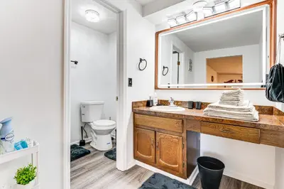a bathroom with a sink and a mirror at Shop, Golf and Explore Home 14 Mi to Columbus! in Pickerington