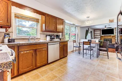 a kitchen with wooden cabinets and a table and chairs at Shop, Golf and Explore Home 14 Mi to Columbus! in Pickerington