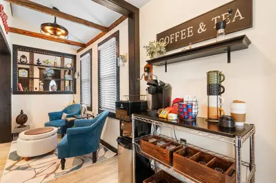 a room with two blue chairs and a counter at Luxurious 1875 centrally located Canton Akron home, expansive primary & sunset view in Uniontown