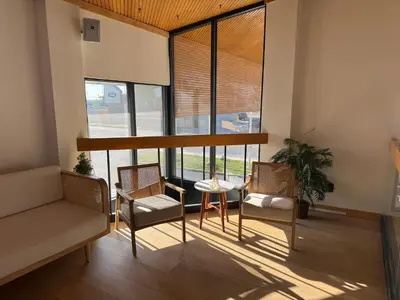 a living room with a table and chairs and a window at 1734 West Hotel in Fort Wayne