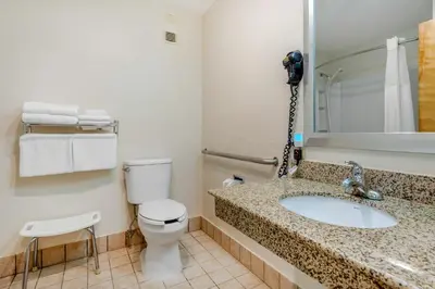 a bathroom with a toilet and a sink at 1734 West Hotel in Fort Wayne