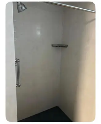 a bathroom with a shower with a white wall at Shaker Heights Apartment near Cleveland Clinic in Shaker Heights