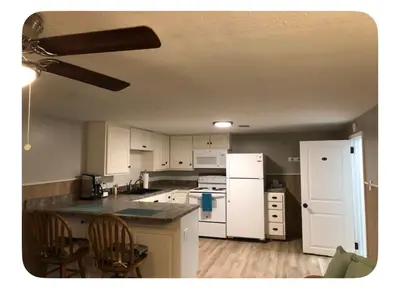 an empty kitchen with white appliances and wooden floors at Shaker Heights Apartment near Cleveland Clinic in Shaker Heights