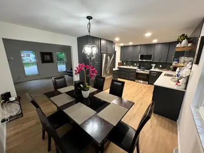 a kitchen and dining room with a table and chairs at Gorgeous Timberwood 3bedr 3bath with basement 4 beds in Sharonville
