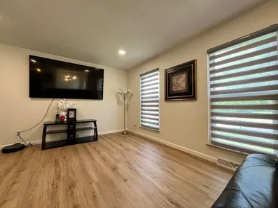 a living room with a couch and a flat screen tv at Gorgeous Timberwood 3bedr 3bath with basement 4 beds in Sharonville