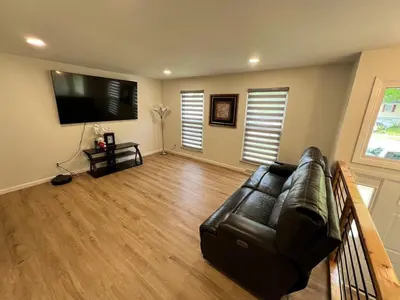 a living room with a leather couch and a flat screen tv at Gorgeous Timberwood 3bedr 3bath with basement 4 beds in Sharonville