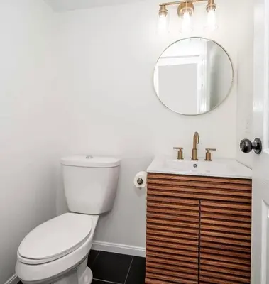 a bathroom with a toilet and a sink and a mirror at Gorgeous Timberwood 3bedr 3bath with basement 4 beds in Sharonville