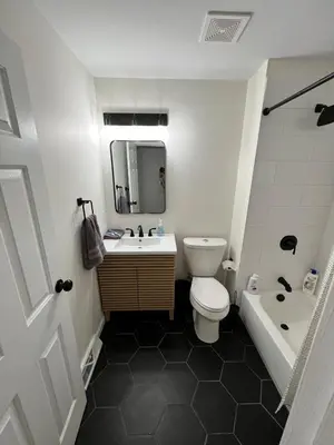 a bathroom with a toilet and a sink and a tub at Gorgeous Timberwood 3bedr 3bath with basement 4 beds in Sharonville