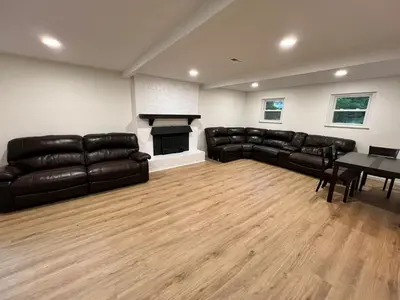 a living room with black leather furniture and a fireplace at Gorgeous Timberwood 3bedr 3bath with basement 4 beds in Sharonville