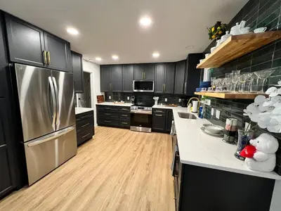 a kitchen with black cabinets and a stainless steel refrigerator at Gorgeous Timberwood 3bedr 3bath with basement 4 beds in Sharonville
