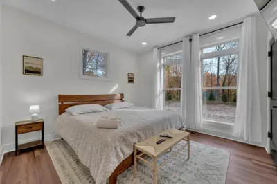a bedroom with a bed and a large window at Luxury Cabin in Hocking Hills The Buffalo in Logan