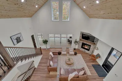 a large living room with a couch and a fireplace at Luxury Cabin in Hocking Hills The Buffalo in Logan