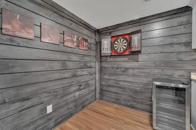 a room with wooden walls and a clock on the wall at Luxury Cabin in Hocking Hills The Buffalo in Logan