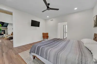 a white bedroom with a bed and a ceiling fan at Luxury Cabin in Hocking Hills The Buffalo in Logan