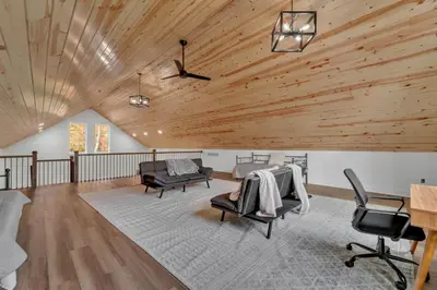 a living room with a wooden ceiling and furniture at Luxury Cabin in Hocking Hills The Buffalo in Logan