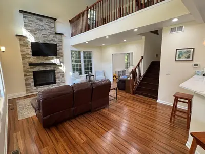 a living room with a couch and a fireplace at Large Family Gathering Home on Kelleys Island in Kelleys Island