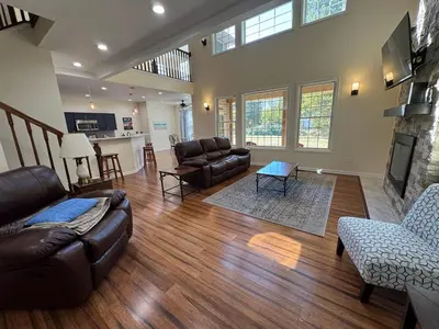a living room with leather furniture and a fireplace at Large Family Gathering Home on Kelleys Island in Kelleys Island