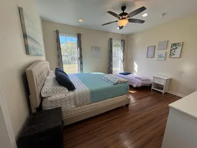 a bedroom with a bed and a ceiling fan at Large Family Gathering Home on Kelleys Island in Kelleys Island