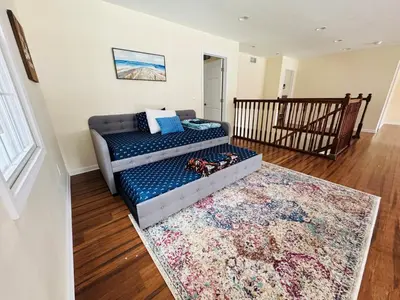 a living room with a couch and a rug at Large Family Gathering Home on Kelleys Island in Kelleys Island