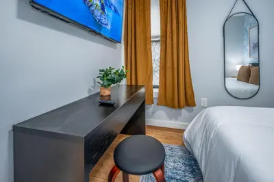 a bedroom with a desk with a chair and a bed at Prime OTR by TQL, Smart TVs, King Bed, Wifi, Sleeps 3ppl, 1st Fl in Cincinnati